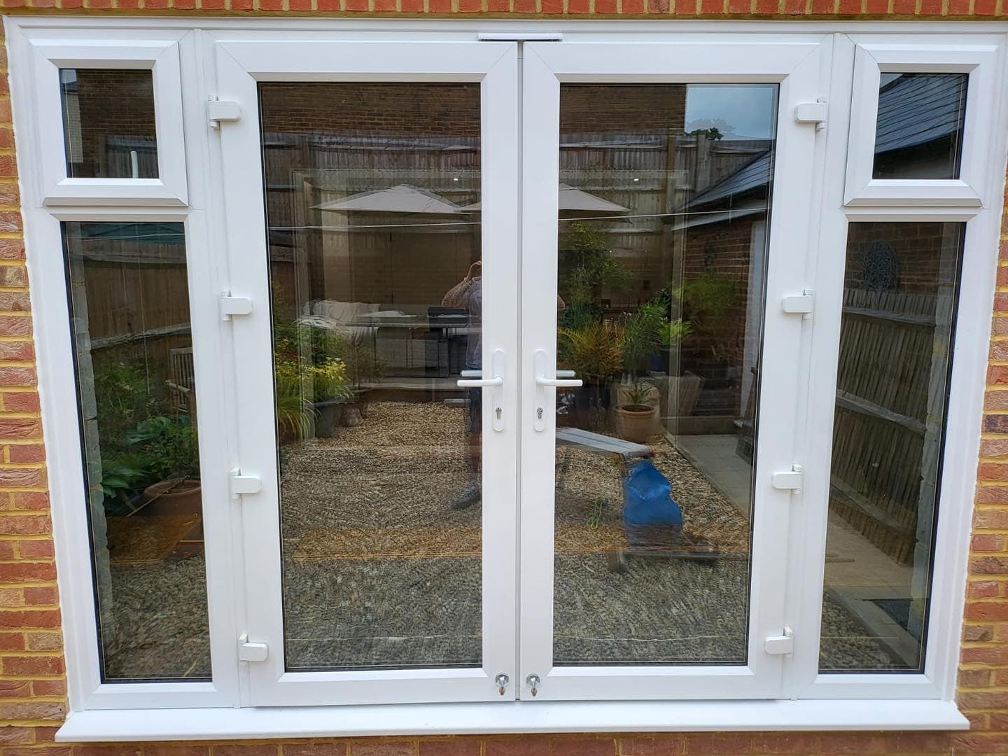White UPVC French doors with garden patio, Surrey
