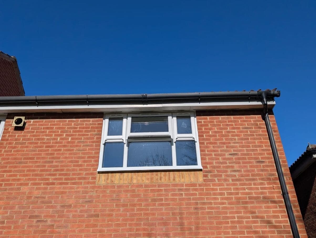 New UPVC roofline fascias and guttering against blue sky — Surrey, by A1 Window Construction Ltd