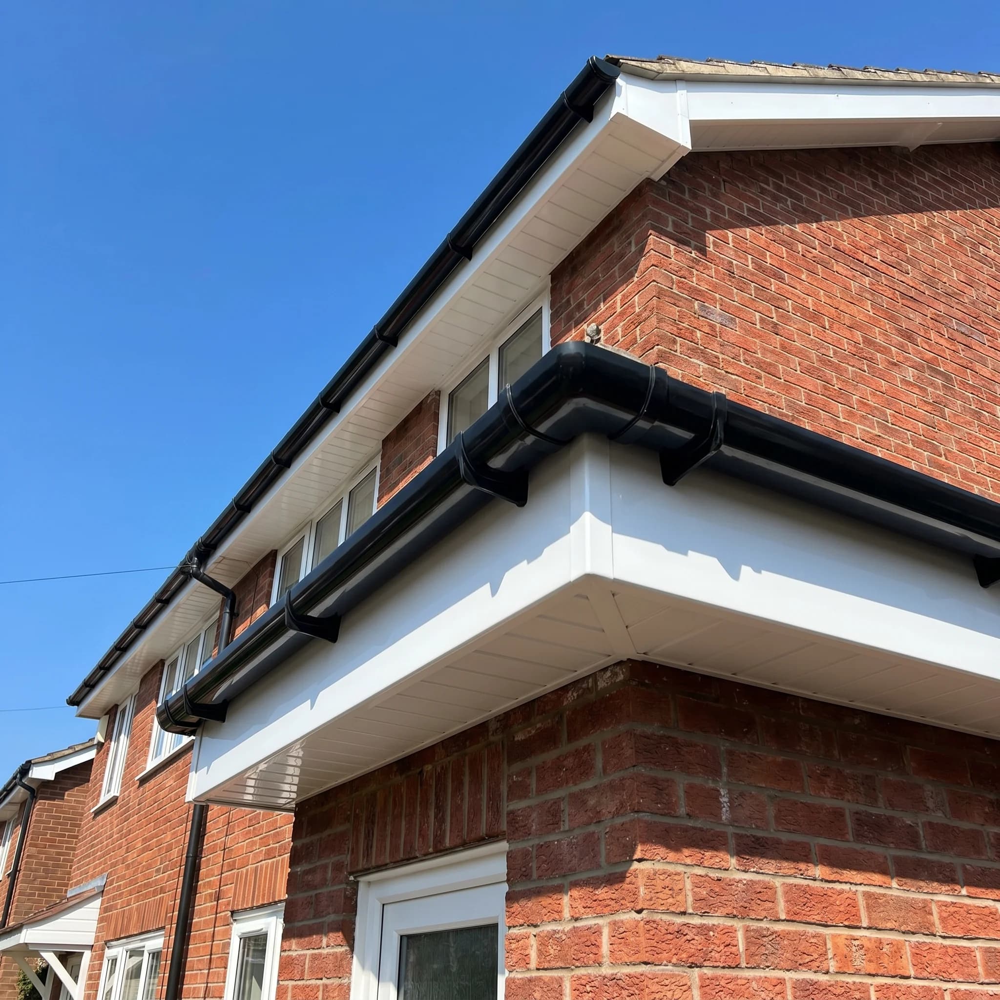 New UPVC roofline fascias guttering blue sky Surrey