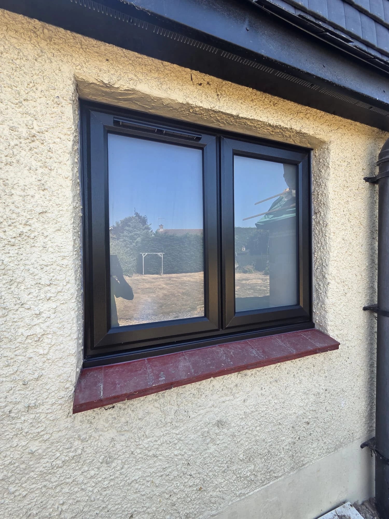 Two-light black casement with a slim trickle vent