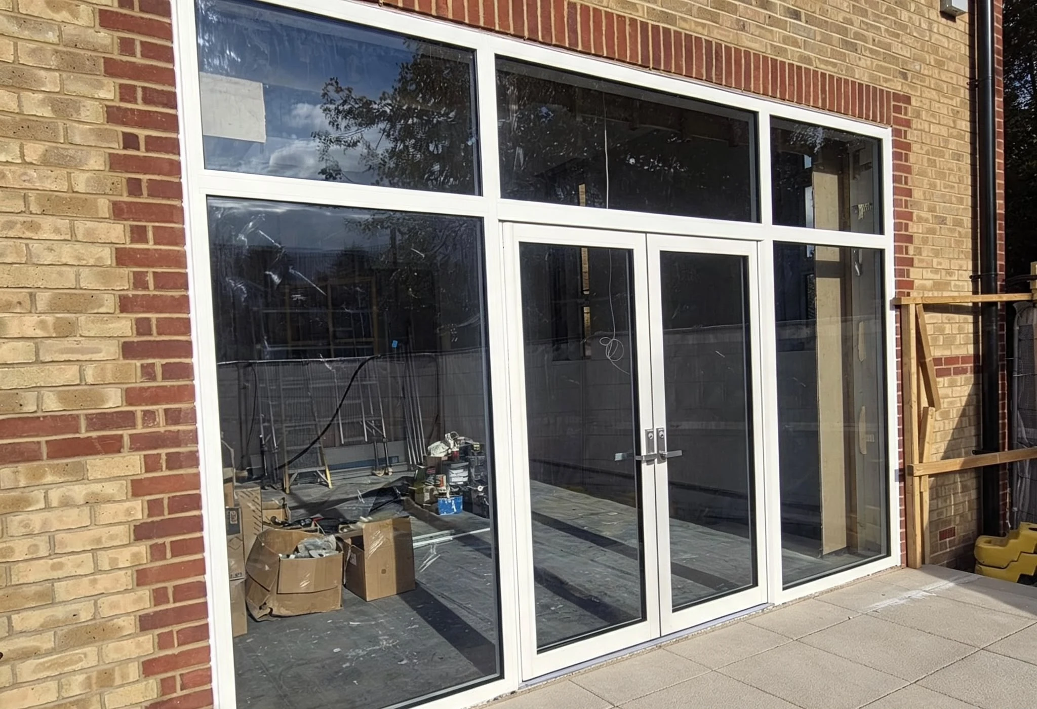 Both commercial frontages side by side on the new-build block