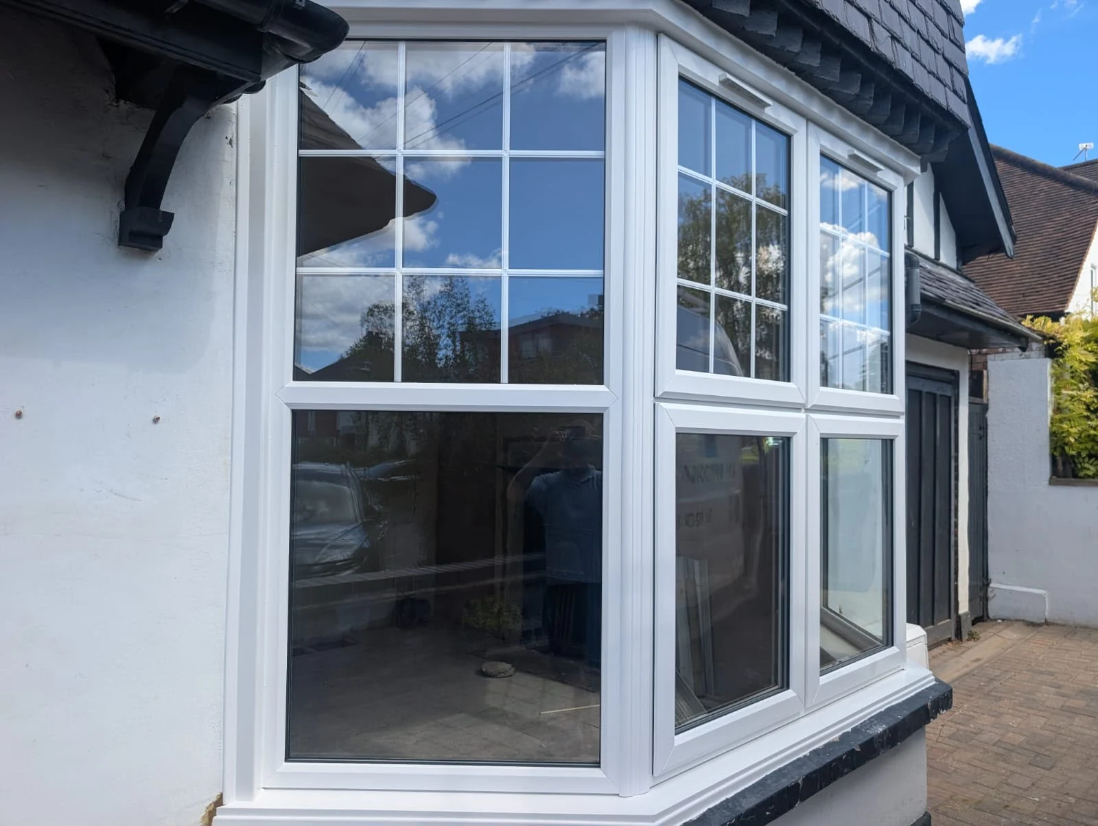 White Georgian-bar bay window on a mock-Tudor home — by A1 Window Construction Ltd